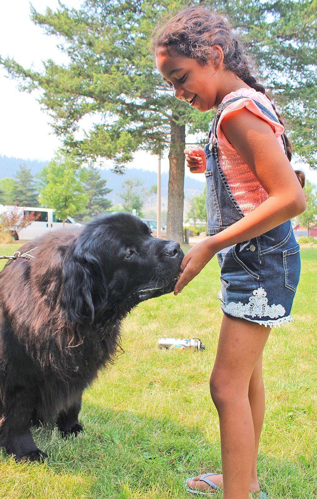 Gia cheerfully pets Winston